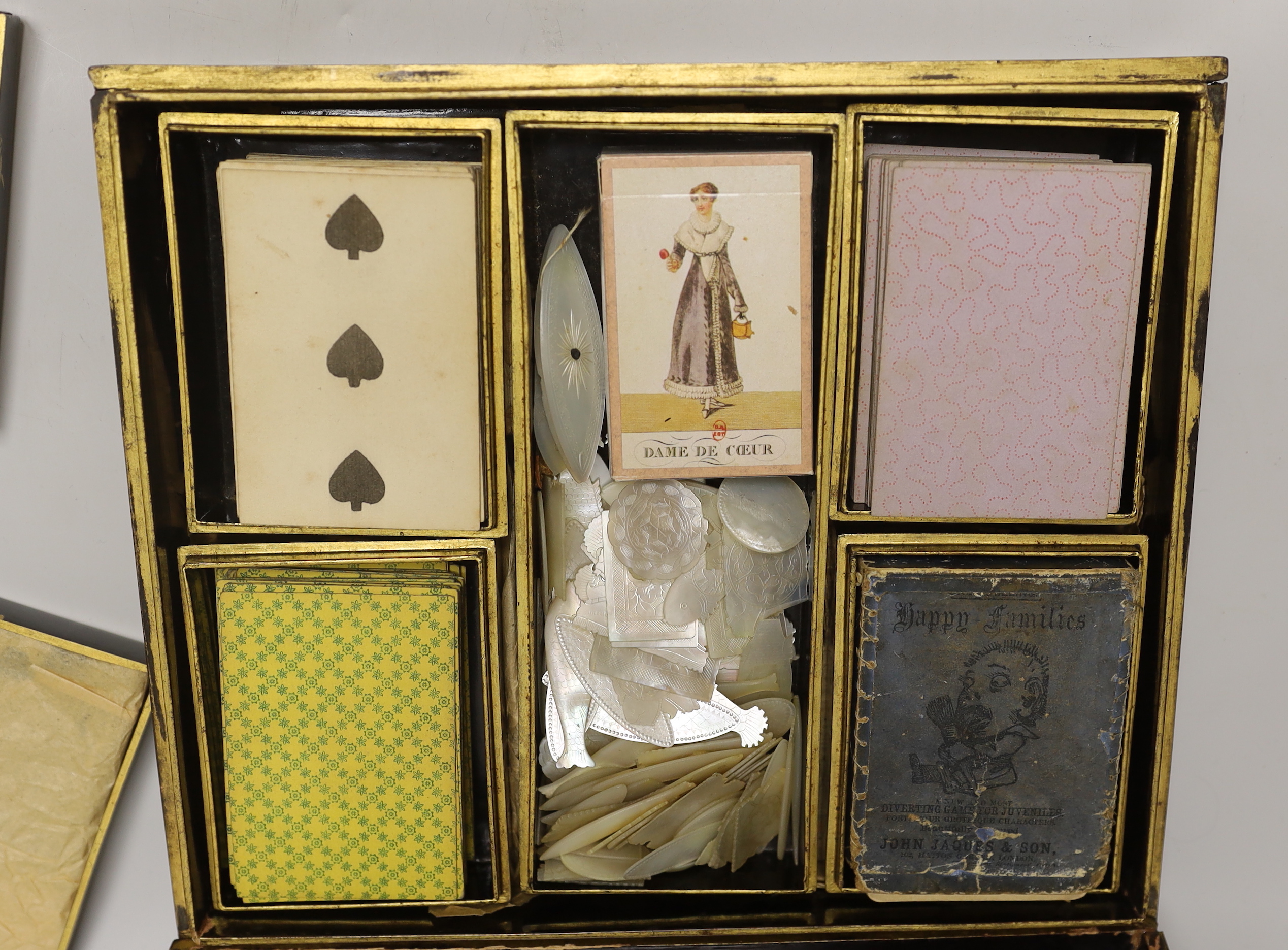 A mid 19th century Chinese export gaming set with mother of pearl counters, contained in a mid 19th century Canton gilt decorated like a box with lidded containers, 29cm